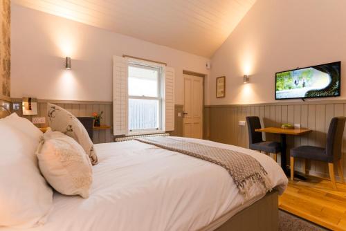 a bedroom with a bed and a tv on the wall at Irvine Bay in Irvine