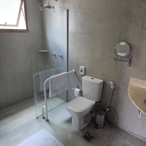 a bathroom with a toilet and a shower and a sink at Studio Corcovado in Rio de Janeiro