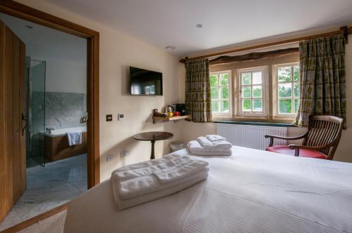 a bedroom with a bed with two towels on it at The Fleece Inn in Shireshead