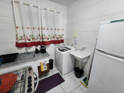 un piccolo bagno bianco con lavandino e servizi igienici di Apto 32. Lindo, aconchegante e completo. a Boituva