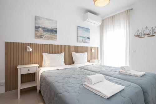 Un pat sau paturi într-o cameră la Villa Conchas by Algarvemanta