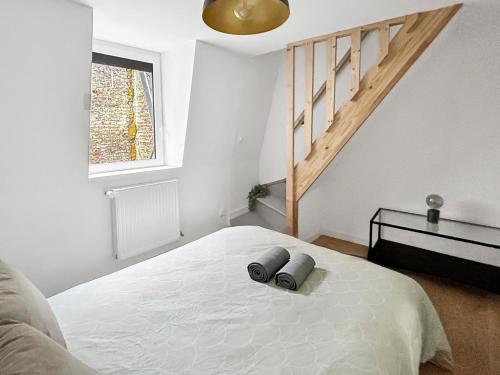 a bedroom with a bed with two pillows on it at La maison peinte par Eugene Delacroix - Netflix in Cambrai