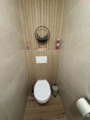 a small bathroom with a toilet with a basket above it at Kamzík 51 Donovaly in Donovaly