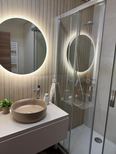 a bathroom with a sink and a glass shower at Kamzík 51 Donovaly in Donovaly