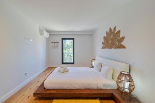 a bedroom with a large bed with a teddy bear on it at Quinta View Apartment, By Home Match in Setúbal