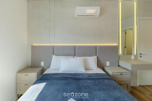 En eller flere senge i et værelse på Acomodações modernas e completas no centro turístico de Gramado - CBGs