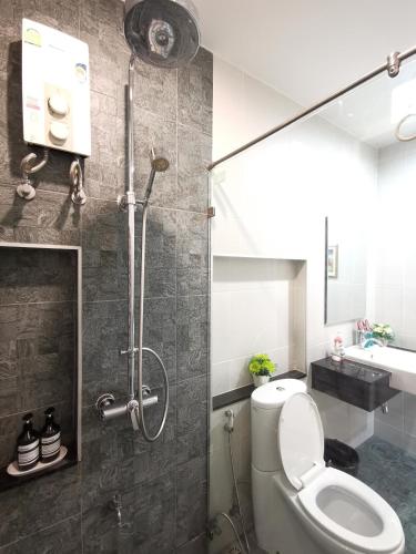 a bathroom with a shower with a toilet and a sink at Home Base at Krabi in Ban Khlong Chi Lat
