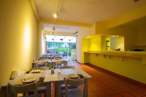 a restaurant with tables and chairs and a counter at Vilaró Art Wine Hotel in Buenos Aires