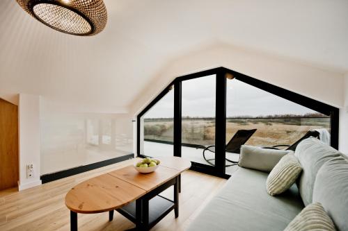 a living room with a couch and a table at BlueApart Jeżynowa Jastarnia in Jastarnia