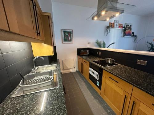 a small kitchen with a sink and a stove at The Athenaeum in Sunderland
