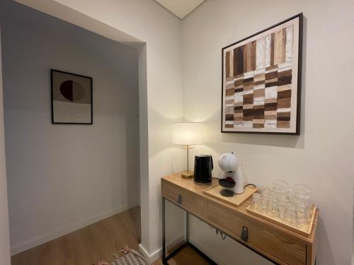 a room with a table with a lamp and glasses on it at MyStay Porto Urban Park in Porto