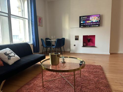 a living room with a couch and a table at The Athenaeum in Sunderland