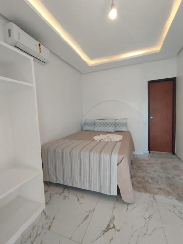 Ένα ή περισσότερα κρεβάτια σε δωμάτιο στο Suíte Master Atins