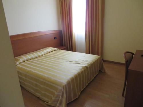 Ένα ή περισσότερα κρεβάτια σε δωμάτιο στο Ristorante Albergo Wada