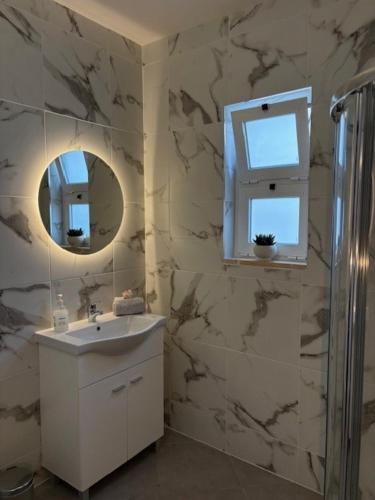 a bathroom with a sink and a mirror at Private 3 bedroom villa in Salema amazing views in Salema