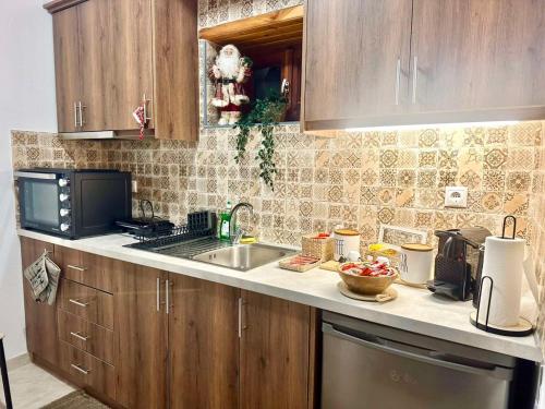 a kitchen with a sink and a microwave at Pindus Nest in Metsovo