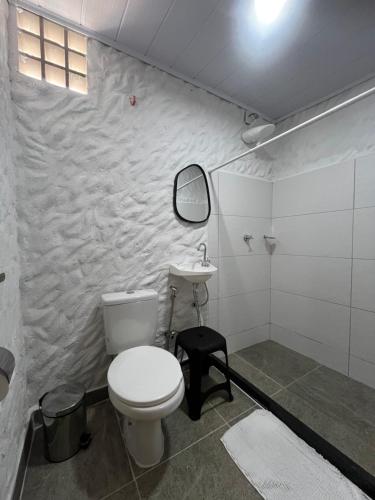 a bathroom with a toilet and a sink at Flor do Mar - Hospedaria in Santa Cruz