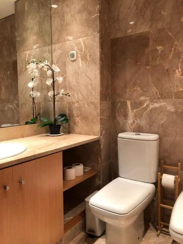 a bathroom with a toilet and a sink at Parque das Nacoes River view ,free wifi in Lisbon