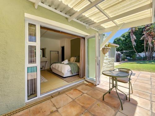 a patio with a bed and a table at 70 on Brander in Cape Town