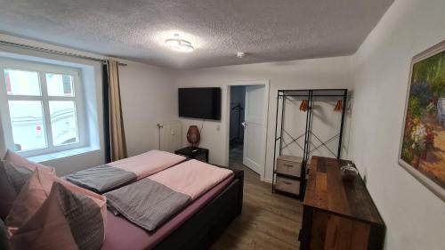 a bedroom with a bed and a large window at Ferienwohnung Hugos Altstadt in Pirna