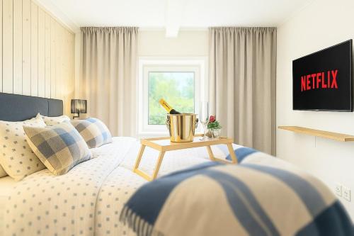 a bedroom with a bed with a table on it at Luxury Rural Retreat with Jacuzzi near Lund & Malmö in Kävlinge