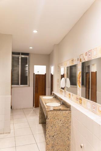 a bathroom with two sinks and two mirrors at Che Lagarto Hostel Copacabana in Rio de Janeiro