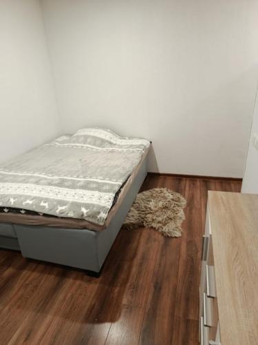 a bedroom with a bed and a rug on a wooden floor at Studio Art in Sillamäe