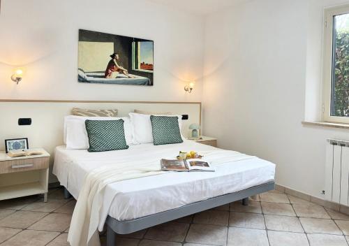 a bedroom with a large bed with a book on it at Holihome Vascello B21 in Tortoreto Lido