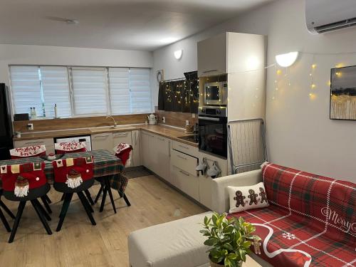 a kitchen with a couch and a table in a room at Trinity House in Obrochishte