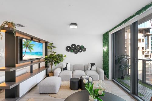 a living room with a couch and a tv at High-Rise Luxury Condo in Downtown Miami in Miami