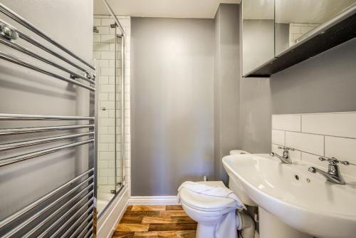 a bathroom with a toilet and a sink at NEW! Private Driveway, Spacious, 2 Bathroom, Fast WiFi in Berkswell