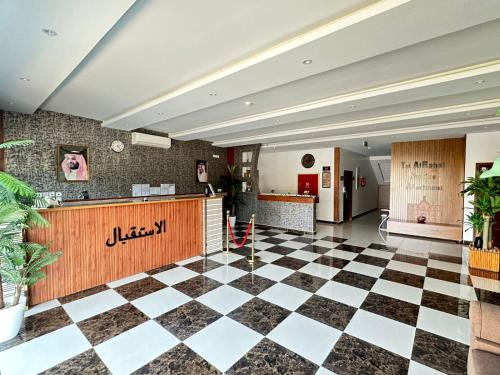 a lobby with a checkered floor at تاج 2 in Al Kharj