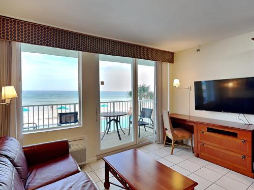 a living room with a couch and a flat screen tv at Harbour Beach Resort 203 in Seabreeze