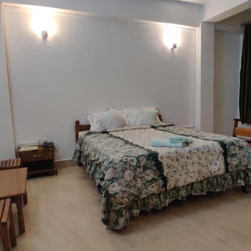 a bedroom with a large bed in a room at Arara Group Hotel Majuli in Majuli