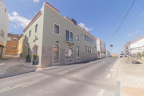an empty street with a building on the side of the road at Galega Villas in Milharado