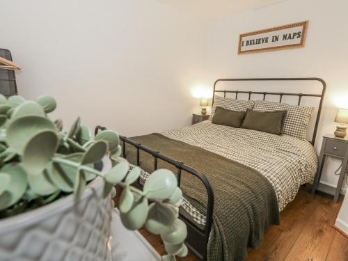 a bedroom with a bed and a sign on the wall at Betty's Buoy in Weymouth