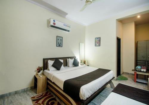 a bedroom with a large bed and a television at Amer Classic - A Heritage Stay Near Amer Fort in Jaipur
