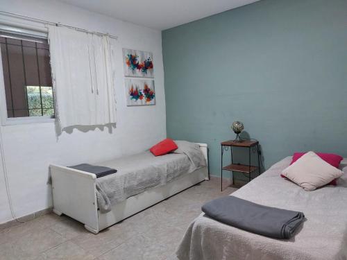 Ένα ή περισσότερα κρεβάτια σε δωμάτιο στο Casa en villa amancay, villa general belgrano