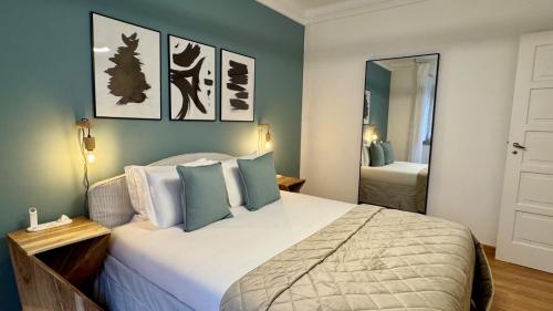 a bedroom with a large bed and a mirror at WHome Charming & Stylish Apartment in Benfica in Lisbon