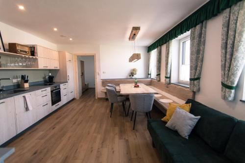 a kitchen and living room with a couch and a table at ReiWaSchHOF in Dobersberg