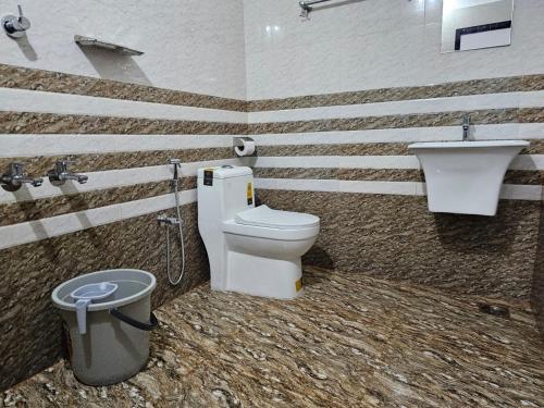 un baño con inodoro y lavabo en Guruvayur Nest Homestay, en Guruvāyūr
