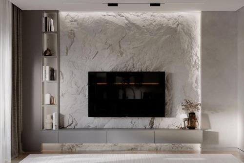 a living room with a tv on a marble wall at Ático de lujo para 7 personas in Cartagena de Indias