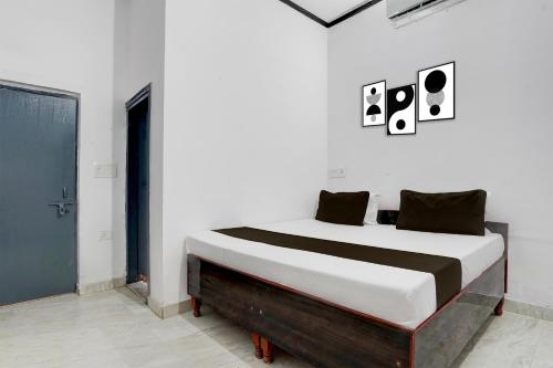 a bedroom with a large bed in a white room at Hotel O Shubh Residency in Bhundsi