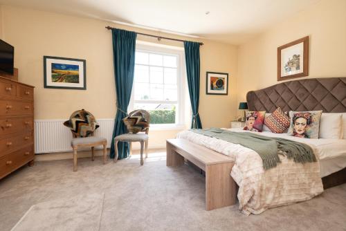 a bedroom with a large bed and a window at The Old Vicarage in Wadebridge