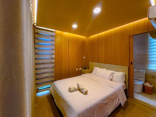 a bedroom with a bed with a pair of shoes on it at Akoma in Kokrobite