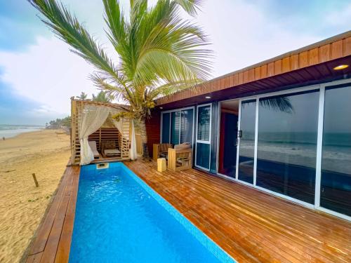a house on the beach with a swimming pool at Akoma in Kokrobite