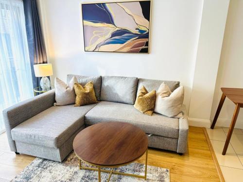 a living room with a couch and a coffee table at Westferry Deluxe Apartment 3 in London
