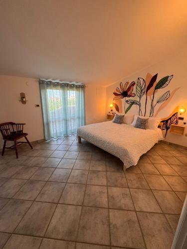 a bedroom with a bed with a flower mural on the wall at Villa Ninnì in Treglio