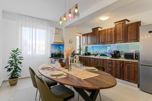 a kitchen with a wooden table and chairs and an aquarium at Luxury 2BR Apartment - Amazing Terrace in Braşov