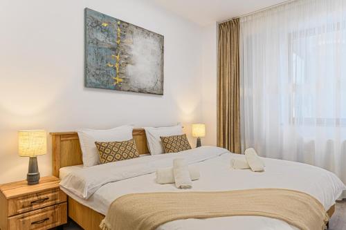 a bedroom with a large bed and a window at Luxury 2BR Apartment - Amazing Terrace in Braşov